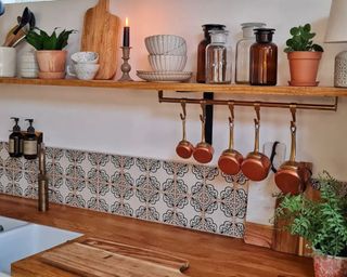 Kitchen with tile backsplash and copper measuring cups