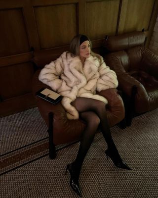 Nitsan Raiter in a white faux fur coat