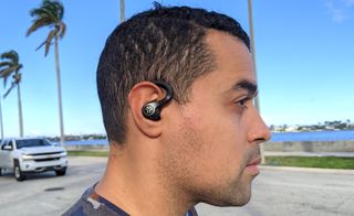 Best running headphones hero image showing our reviewer wearing the JLab Epic Air Sport ANC