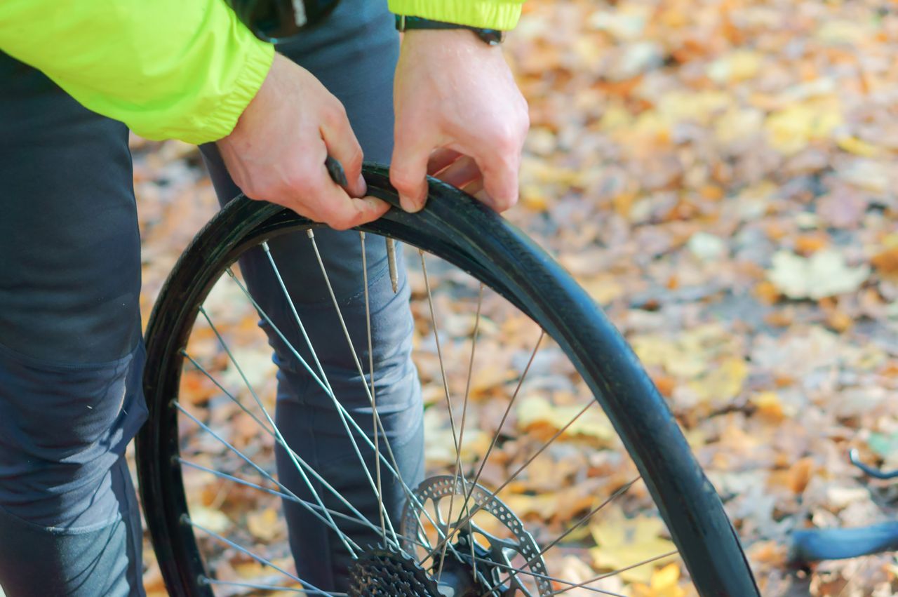 A man removes his tyre from his bike