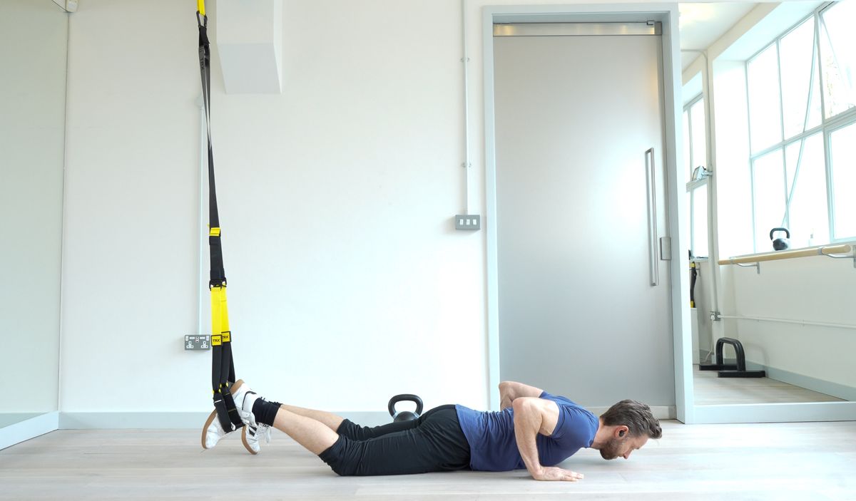 Niko Algieri demonstrates one position of the TRX burpee