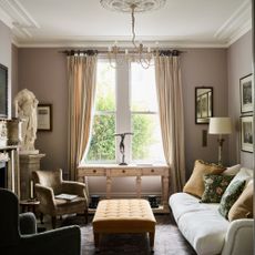 elegant living room decorated in neutral tones with antiques