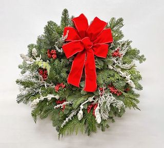 Red bow Christmas wreath made with fresh foliage from Pottery Barn.