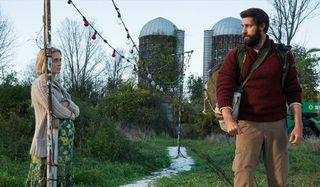 Emily Blunt and John Krasinski outside talking in A Quiet Place