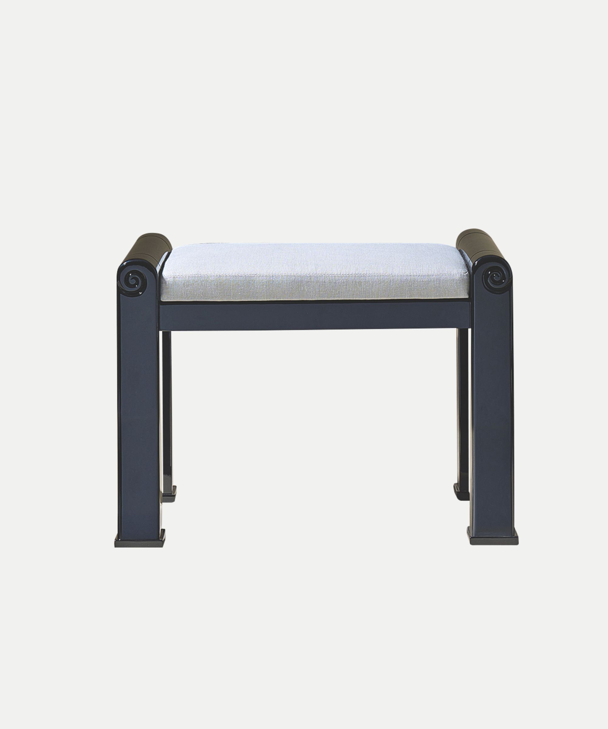 Navy lacquered stool with a grey seat cushion