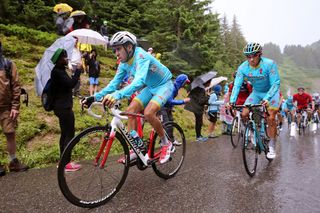 Fabio Aru with Astana teammate Diego Rosa during the wet finale to stage 20