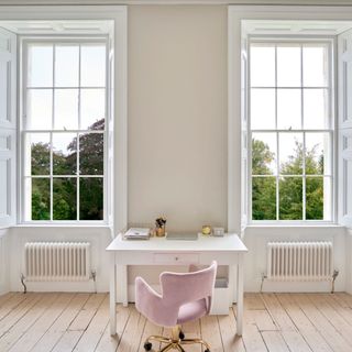 two full sized sash windows in period home cream with white desk and pink chair