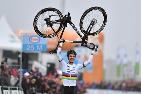 Woet Van Aert lifts his bike over his head as he clinches his second Belgian cyclo-cross title
