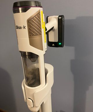 Shark Cordless Detect Pro Auto-Empty System vacuum cleaner emptying dust cup at docking station
