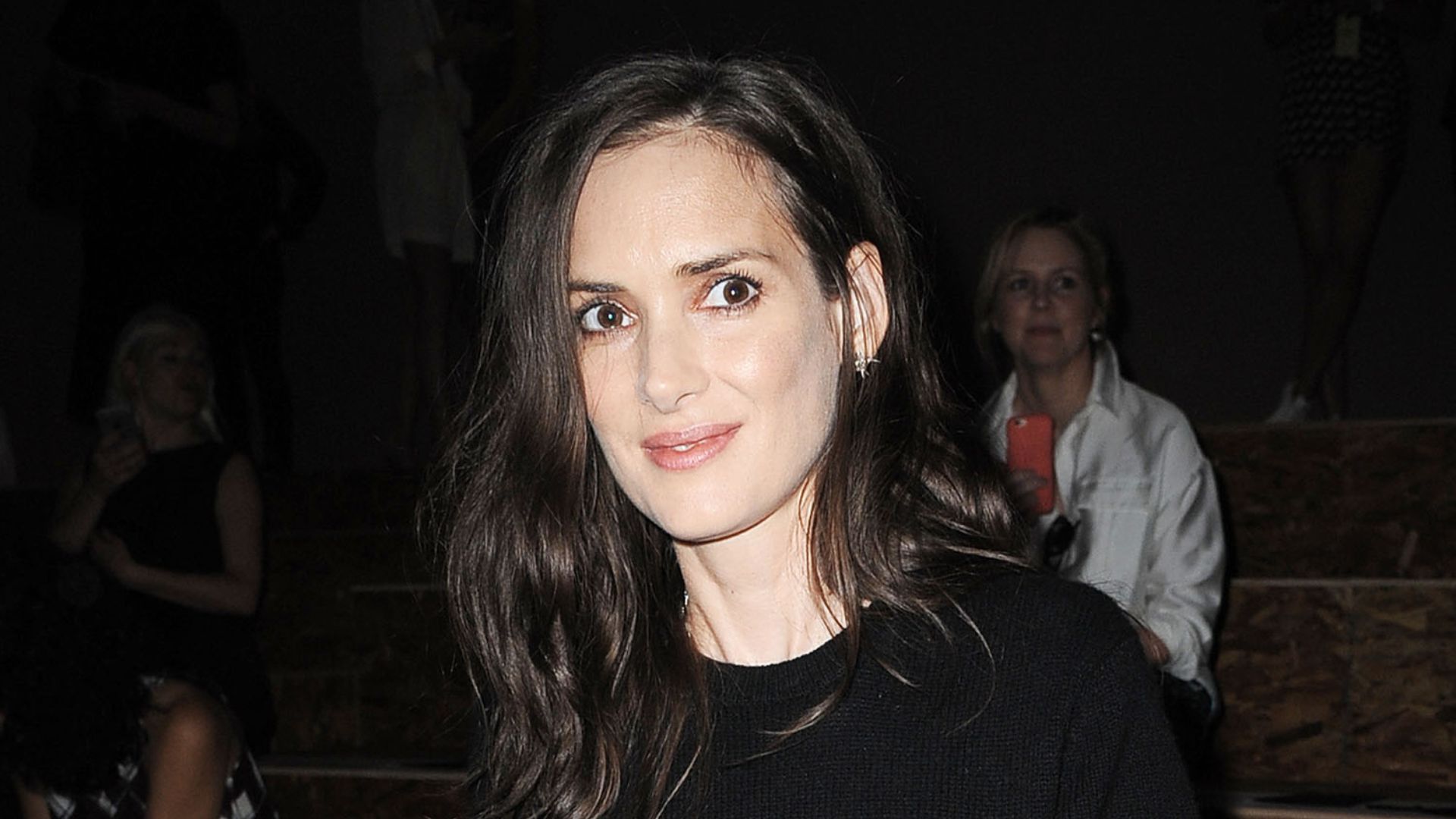 Winona Ryder wearing dinosaur graphic knit jumper at Coach Spring runway show in 2017