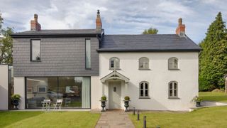 white cottage with grey clad modern side extension
