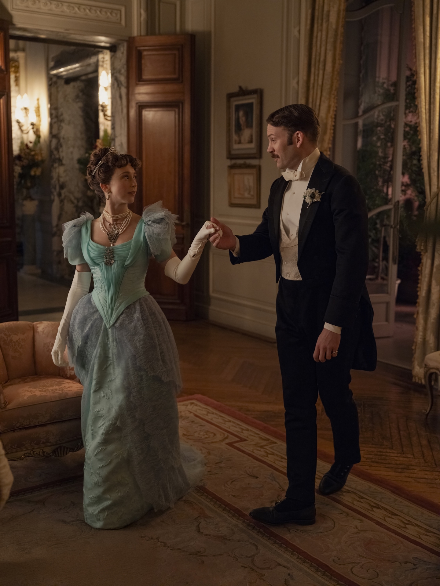 taissa farmiga as gladys and ben lamb as hector holding hands walking together in a still from the gilded age season 3 finale