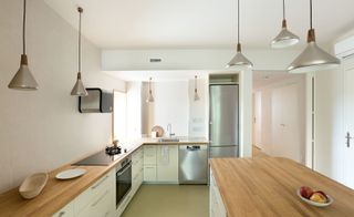 The kitchen is connected to the open plan living space with a sliding wall