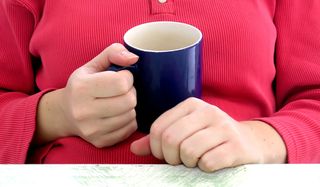 Woman holding coffee cup