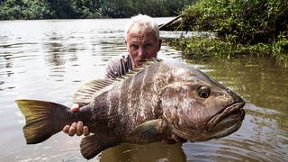 River Monsters host Jeremy Wade holding a giant fish.