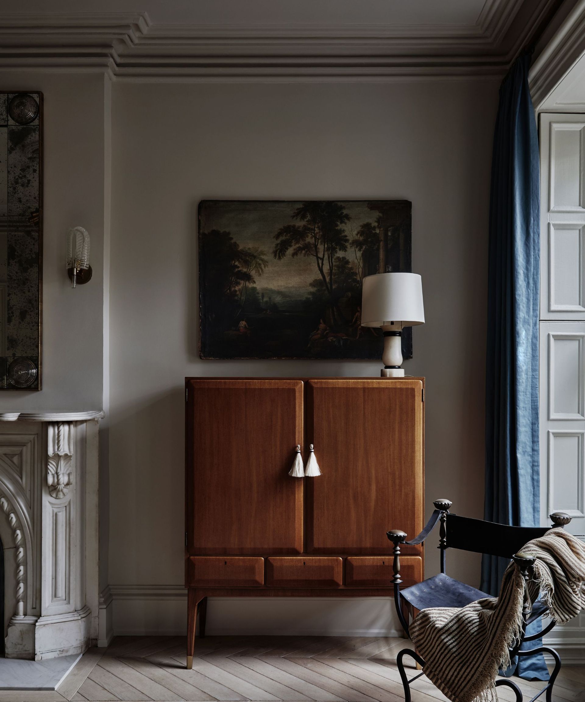 living room with muted color scheme and a vintage wood cabinet with tasselled handles