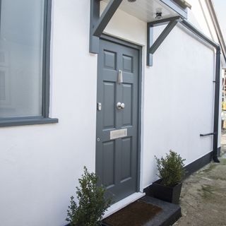 house with white wall and grey door