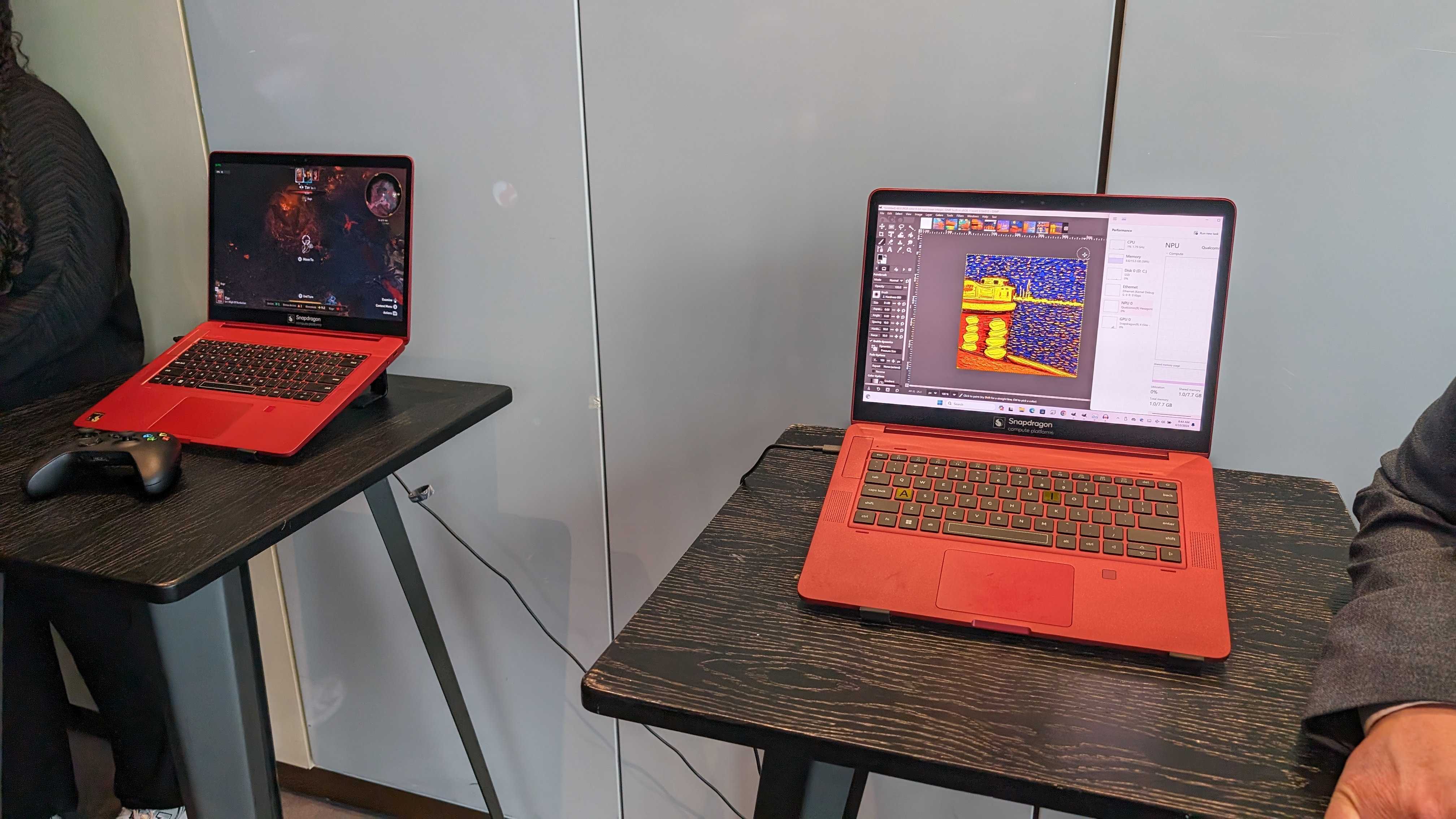 Two Qualcomm Snapdragon X Elite reference laptops running test software.