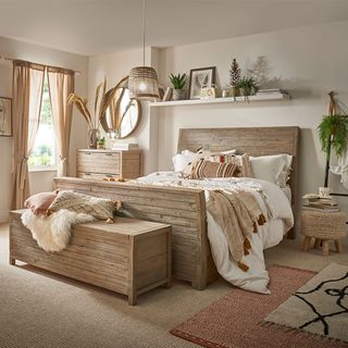 Neutral bedroom with wooden bed and shelves with greenery