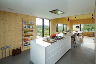grey rubber flooring in white and wood kitchen
