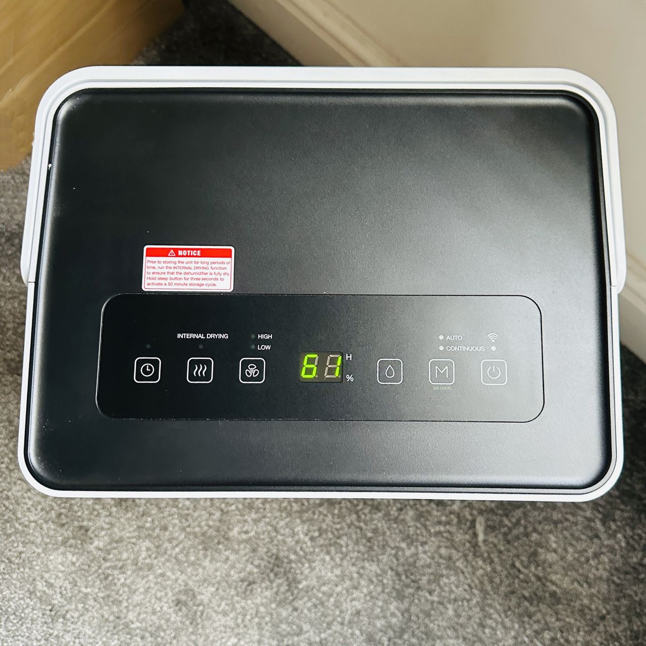The Pro Breeze 30L High Capacity Smart Dehumidifier review being tested in a room with grey carpet