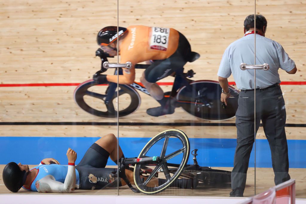 IZU JAPAN AUGUST 07 Matthijs Buchli of Team Netherlands competes as Hugo Barrette of Team Canada falls during the Mens Keirin first round heat 2 of the track cycling on day filthen of the Tokyo 2020 Olympic Games at Izu Velodrome on August 07 2021 in Izu Shizuoka Japan Photo by Justin SetterfieldGetty Images