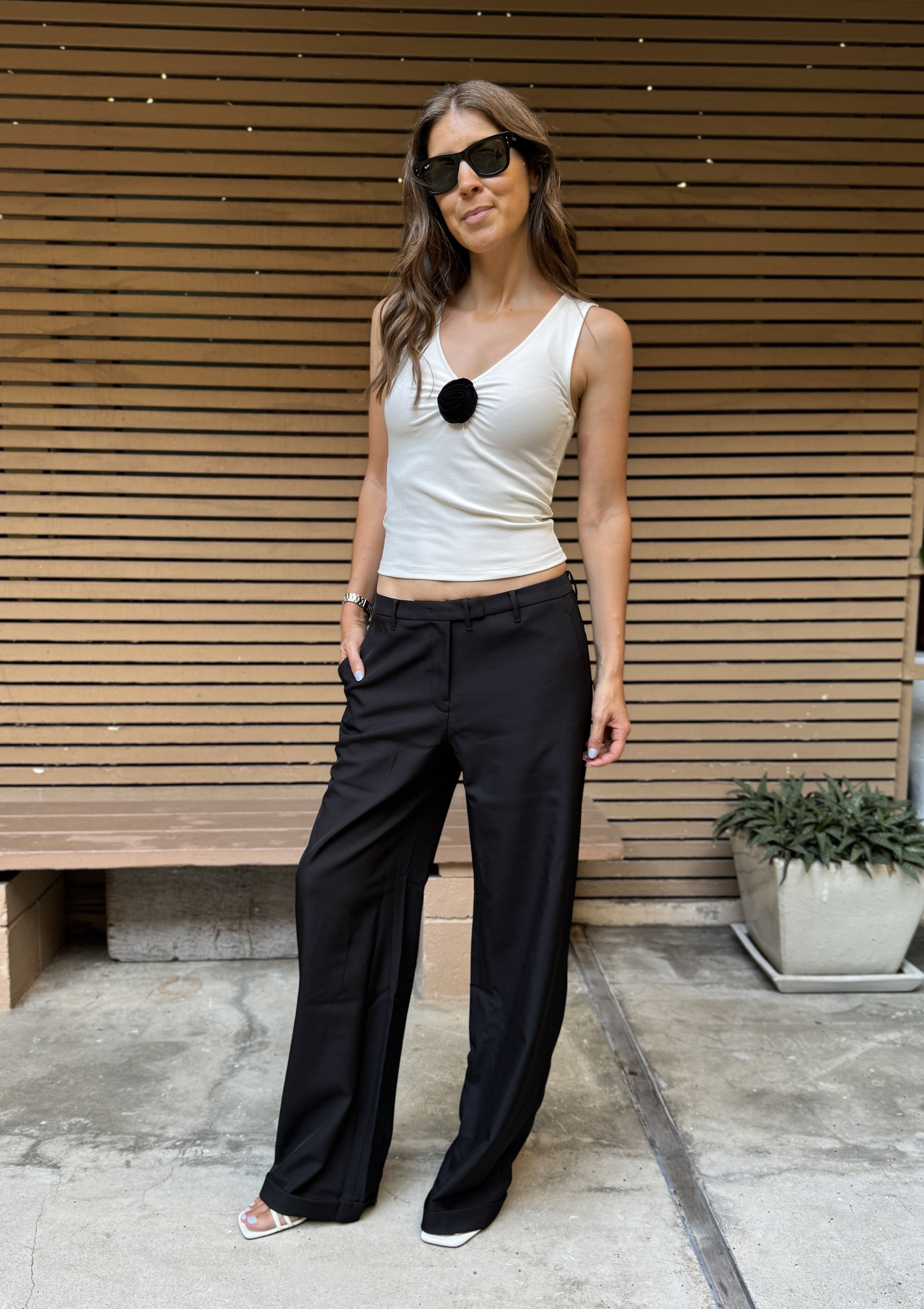 Judith Jones in white top and low-rise black pants