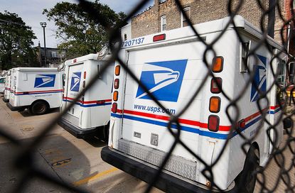 United States Postal Service trucks sit outside the Roberto Clemente Post Office August 25, 2009 in Chicago, Illinois.