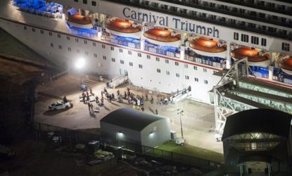 Media await the final unloading of the crippled cruise liner Carnival Triumph Feb. 14 in Mobile, Ala.