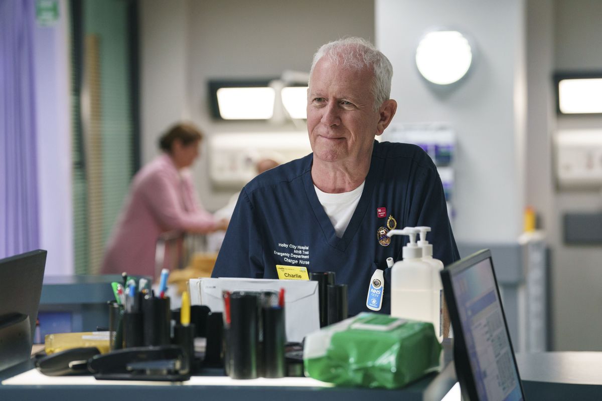 Charlie Fairhead at work smiling. 