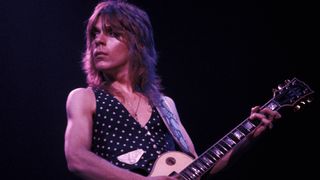 Photo of Randy RHOADS; playing Gibson Les Paul guitar, performing live onstage with Ozzy Osbourne 