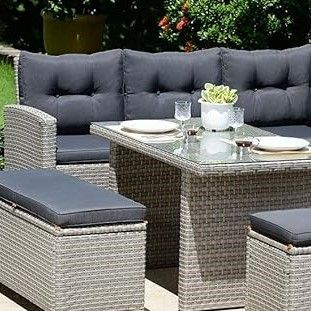 Rattan garden furniture with black cushions