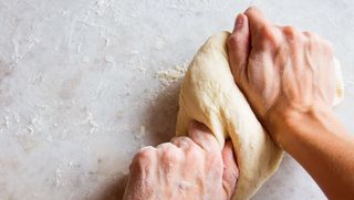 dough being kneaded by hand
