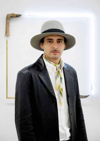 Gabriel Rico with black coat and hat