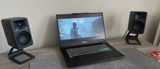 Origin EON17-X v2 gaming laptop between two speakers