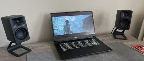 Origin EON17-X v2 gaming laptop between two speakers