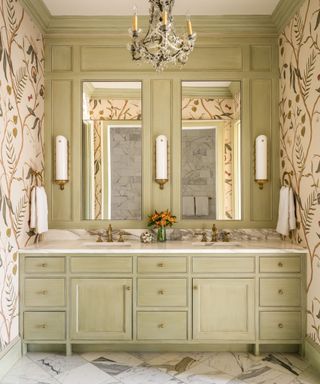 bathroom with chandelier leafy wallpaper and wide pale green vanity