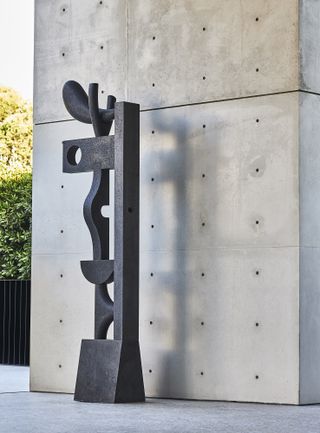 Sculpture beside concrete wall