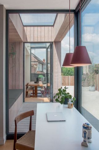 covered integral seating, wrapped in light larch cladding, is cut from the main living spaces