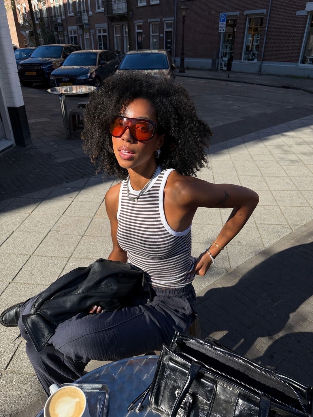 Gen Z influencer wearing summer 2026 microtrend, a pair of oversize shield glasses.