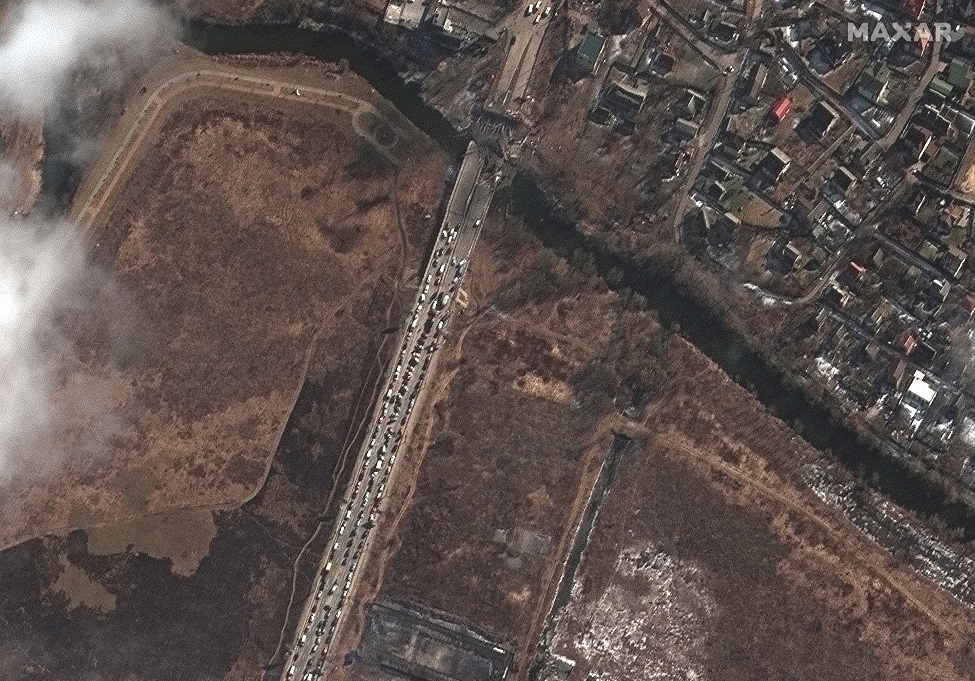 A long line of cars and people leaving Irpin and damaged bridge is visible in this Maxar satellite image taken on March 10, 2022.