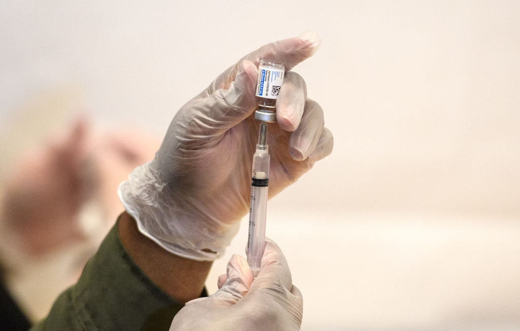 Health care worker prepares Covid-19 vaccine as vaccine passports come into use in England
