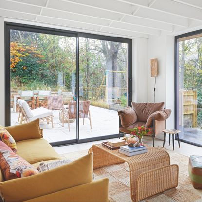 Sliding doors and a fixed window off living room, with slim frames to maximise views of the garden