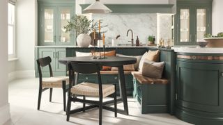 dark green kitchen with built-in seating