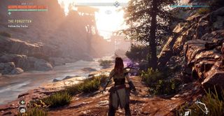 Horizon Zero Dawn Aloy stands near a stream