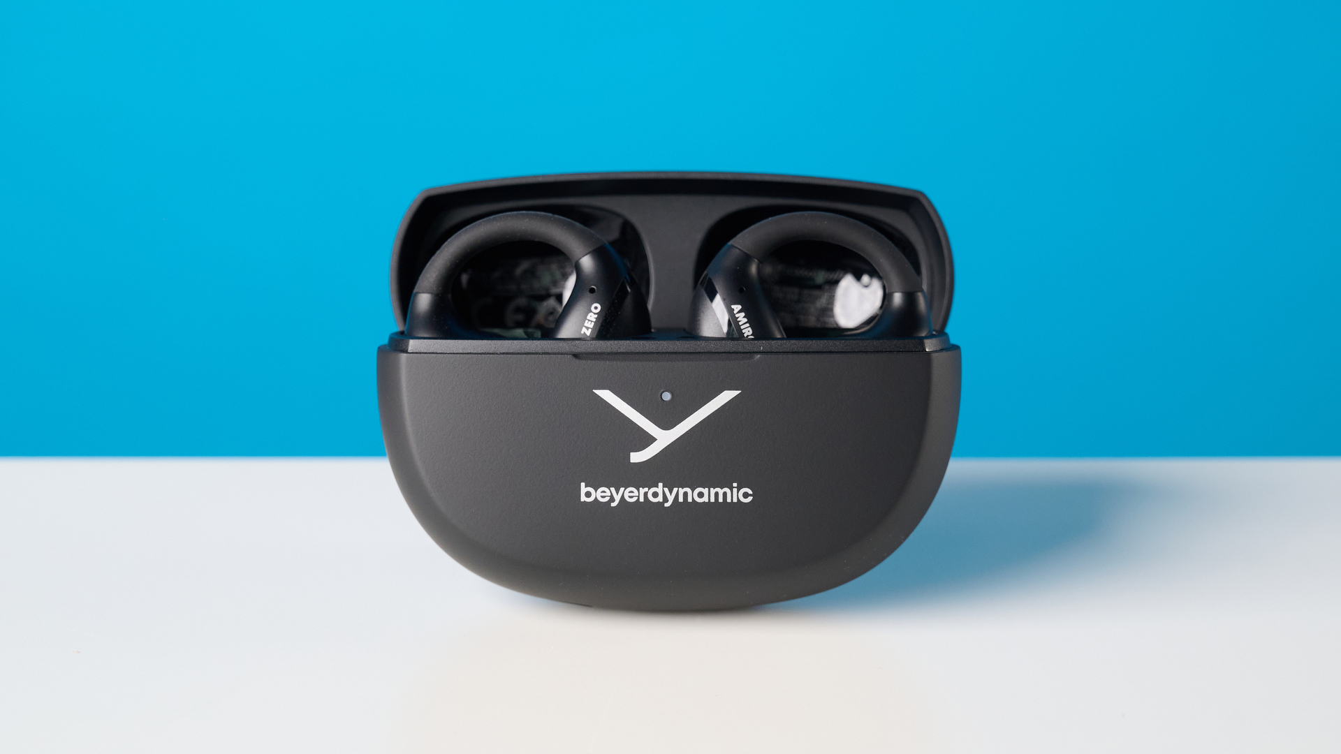 Beyerdynamic Amiron ZERO open-earbuds photographed on a blue background