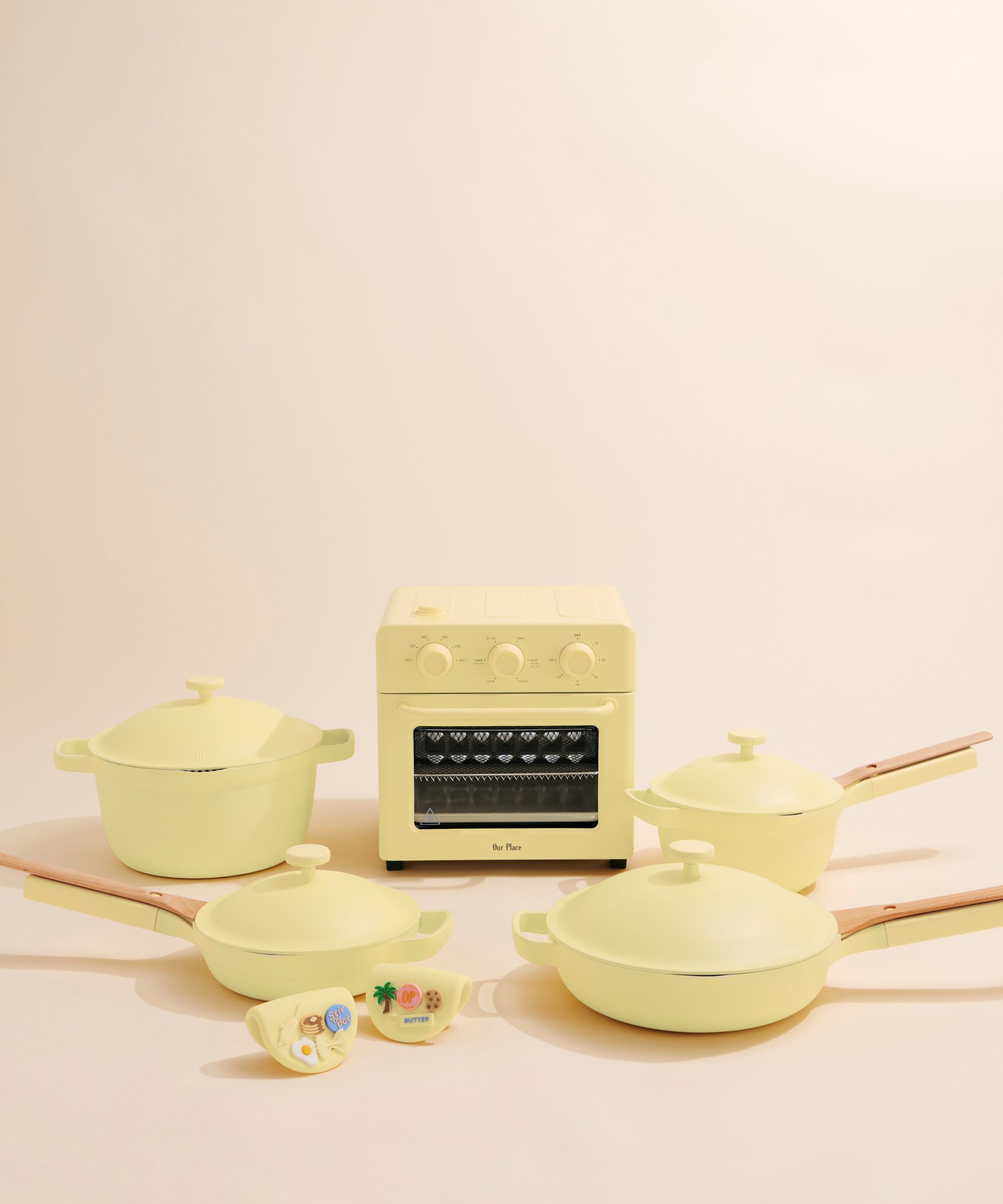 Butter yellow Our Place cookware against a cream background