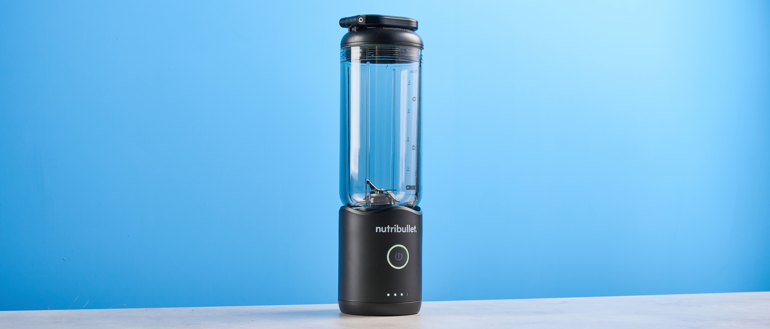 Nutribullet Flex blender photographed on a blue background