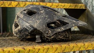 A muddy Kali Cascade MTB helmet