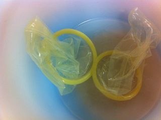 Two used condoms in a cup.